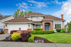 Image of a home with a large green lawn that may be surrendered  to the morgagor under chapter 13.